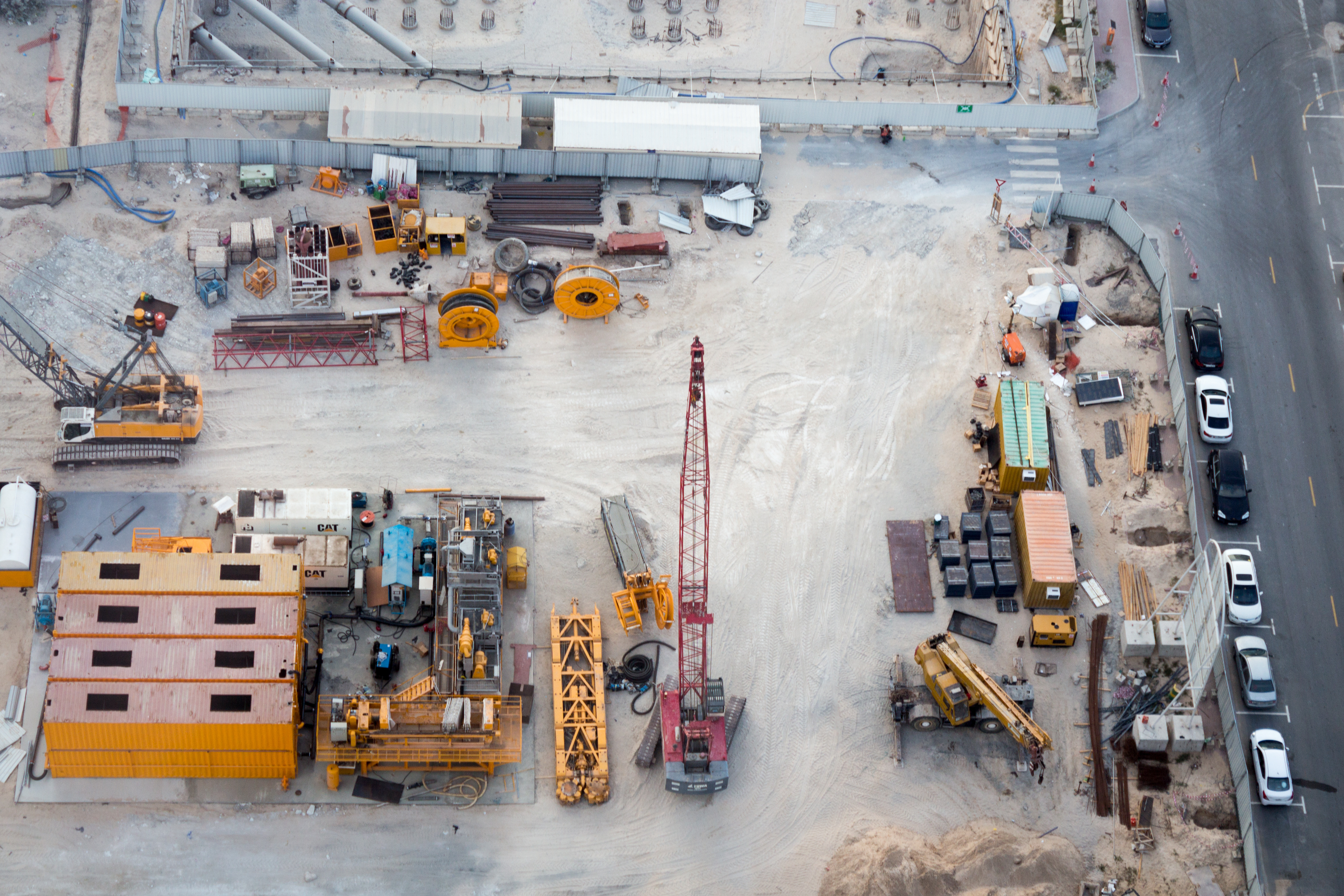 Aerial shot of construction site with equipment in an urban setting