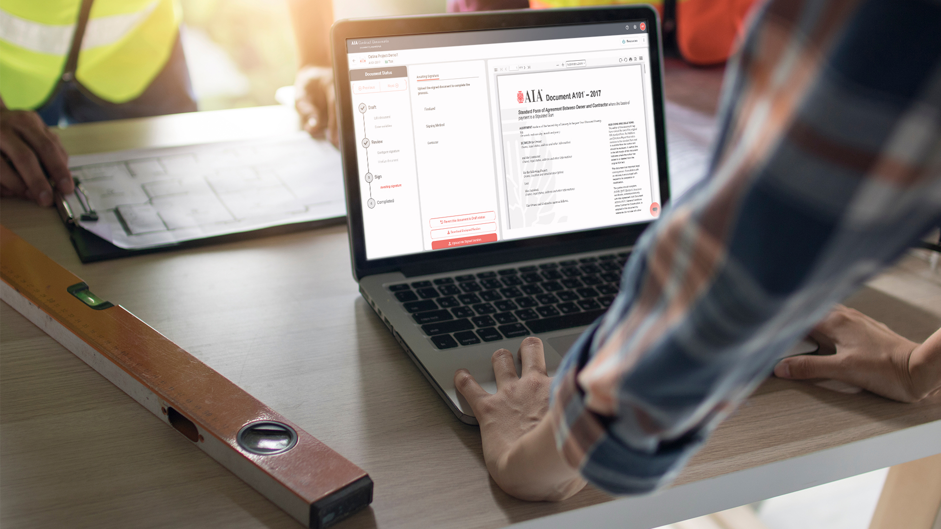 A101-2017 Standard Form of Agreement Between Owner and Contractor on laptop screen in contractor office