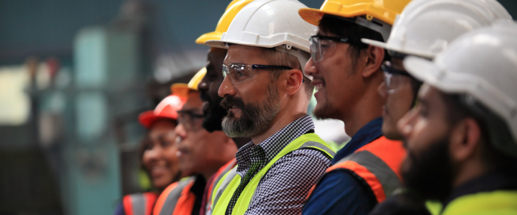 Multiple subcontracting team leads meet on a job site for a daily huddle