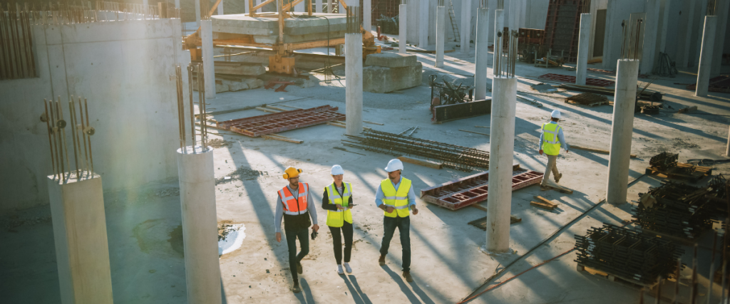 Construction crews walk through the construction stie to review schedules