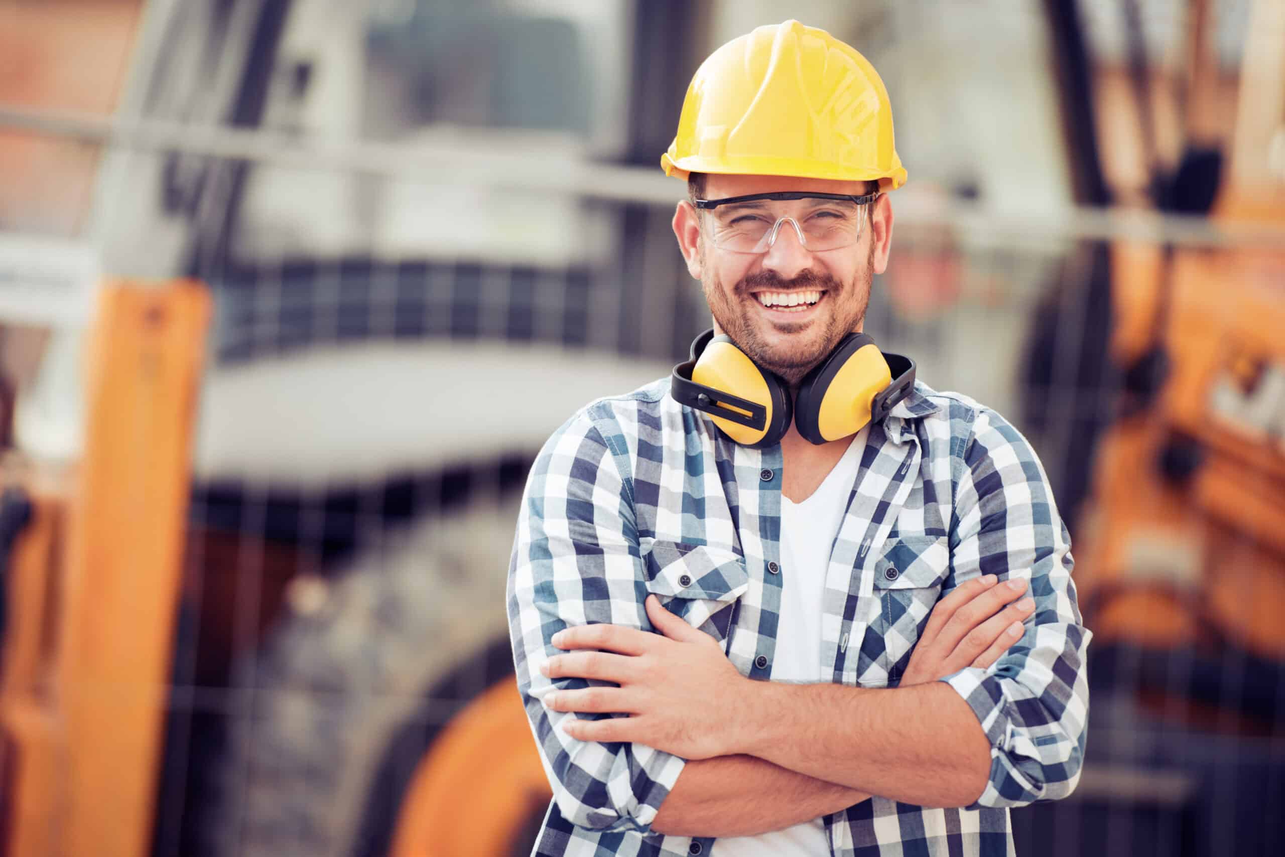 A general contractor smiling on the job site