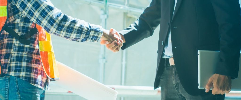 Owner and architect reviewing construction plans together