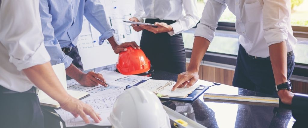 Owner reviewing construction contract documents with project team