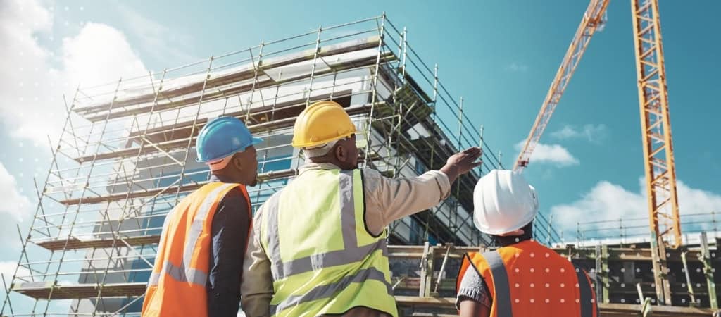 Construction site with contractors discussing project details.