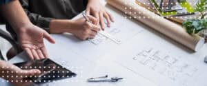 Architects and engineers review blueprints together, the coordination that makes contract risk management work.