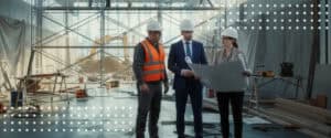 Architects, contractors, and owners review a laptop inside a building under construction, the parties who rely on AIA contract documents.